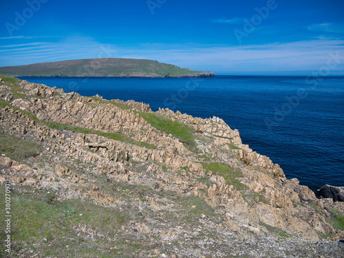 Coastal serpentine rock at the Keen of Hamar Nature Reserve near Baltasound on the island of Unst in Shetland  UK. The Hill of Clibberswick can be seen in the distance.