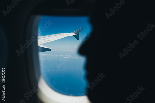 Face silhouette and airplane wing