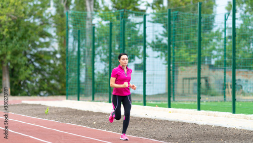 Young woman runner training on an outdoor track