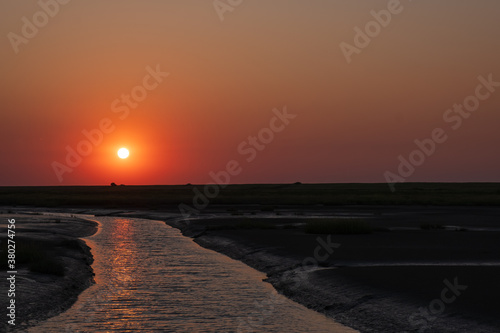 Atmospheric sunset at Langwarder Groden in Butjadingen on the North Sea / Germany photo