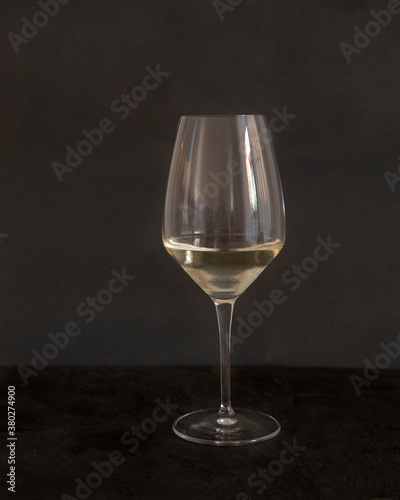 Glass of Pinot Grigio wine on black background. Close up front view