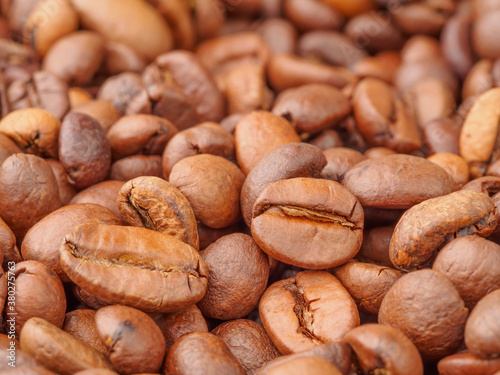 Coffee beans heap closeup macro background, selective focus, low angle