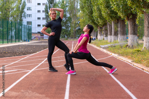 Two woman athletes striking a synchronised pose