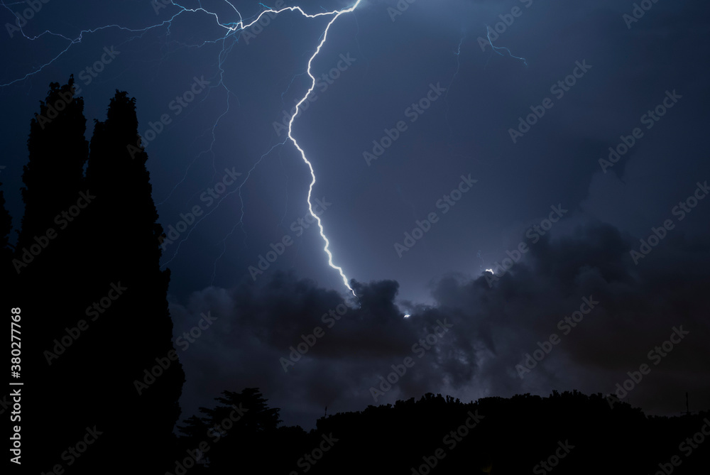 
Lightning storm at night over the city. Concept on the subject of weather, cataclysms (hurricane, typhoon, tornado, storm)