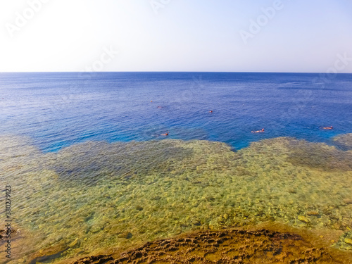 The people snorkeling in blue waters above coral reef on red sea in Sharm El Sheikh, Egypt © Solarisys