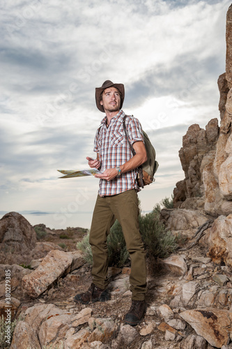 Hiker Using Map and Compass in Wilderness photo