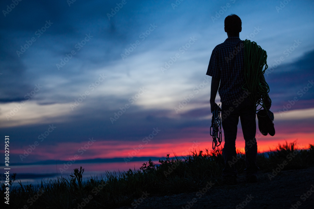 Silhouette of Climber Watching Vibrant Sunset Silhouette of Climber Watching Vibrant Sunset