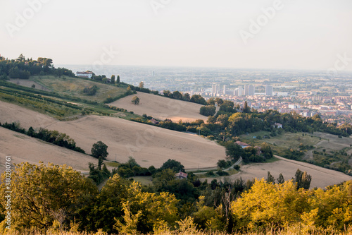 Panoramic view of Bologna from Bolognese hills. The city in background with rural fields and wheat in close up. Emilia Romagna Region, Italy © Giampaolo