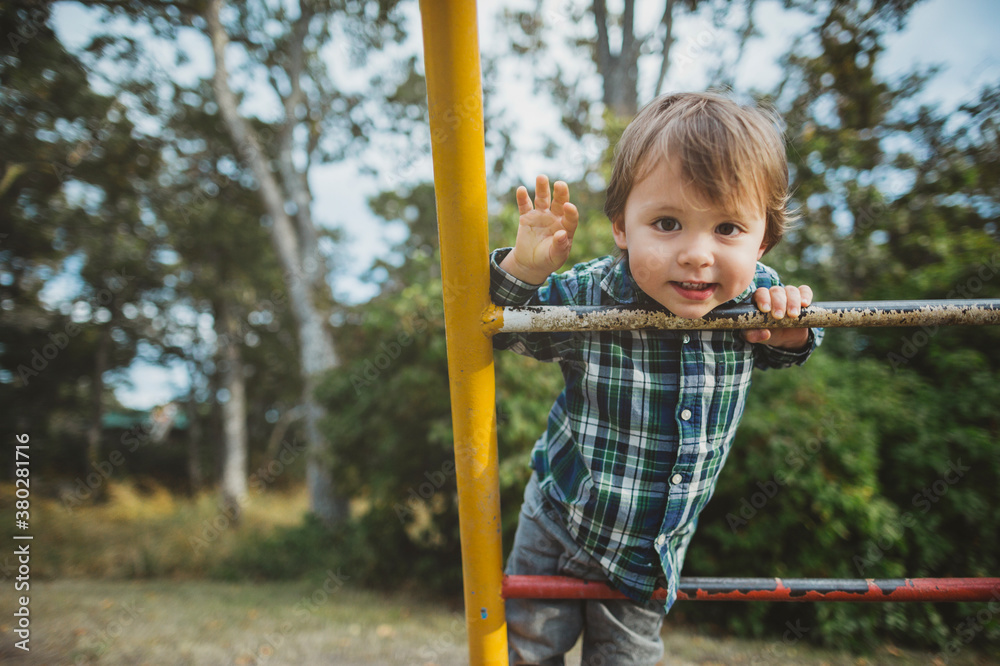 Young mixed race (asian caucasian) toddler boy climbing at playground Young mixed race (asian caucasian) toddler boy climbing at playground