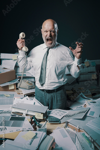 Stressed business executive overwhelmed by work