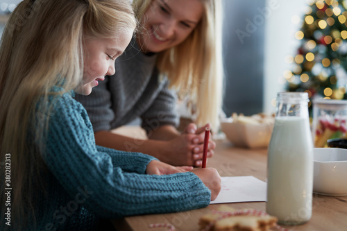 Girl writing a letter to Santa Claus