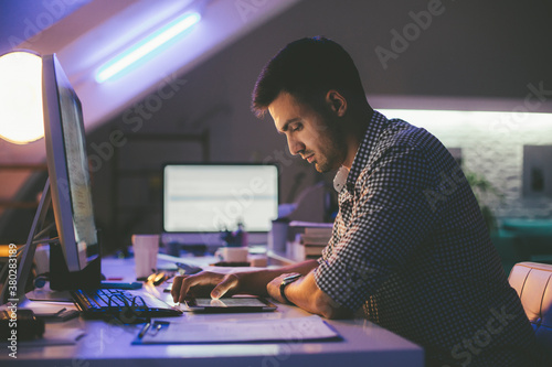 Programmer Looking at a Computer Code on a Tablet