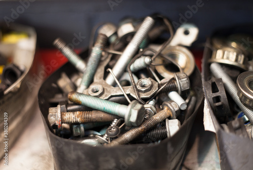 Assortment of screws, bolts and other metal items in a repair shop photo