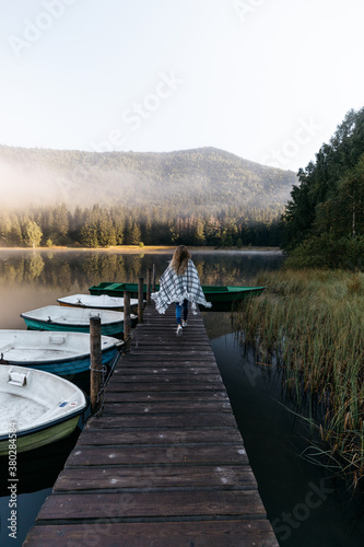 Woman standing on the woode...
