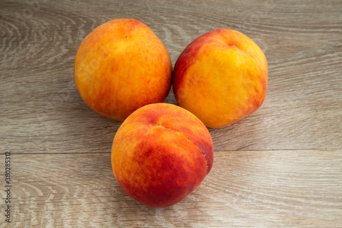 Ripe peaches on a white background and a tree background