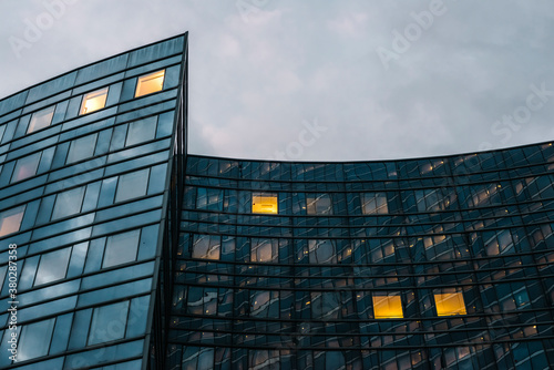 Illuminated office windows in contemporary building at twilight photo