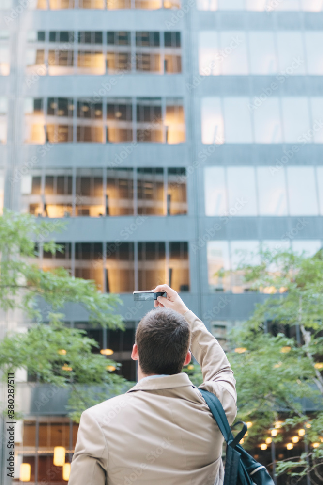 Young Professional Man Taking Photo with Smartphone Camera Technology in New York's Wall Street Business District Young Professional Man Taking Photo with Smartphone Camera Technology in New York's Wall Street Business District