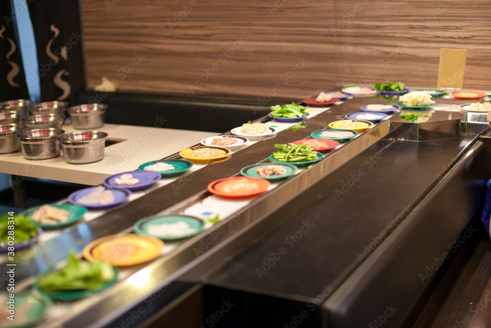 Colorful plates on a Sushi go round restraunt Colorful plates on a Sushi go round restraunt