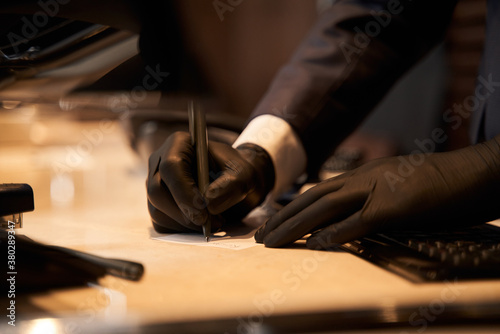 Person in rubber gloves making notes on piece of paper