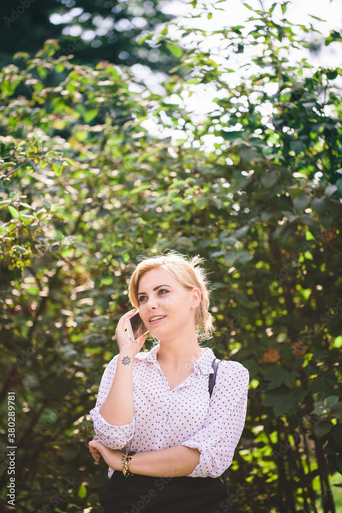 Beautiful woman telephoning outdoors Beautiful woman telephoning outdoors