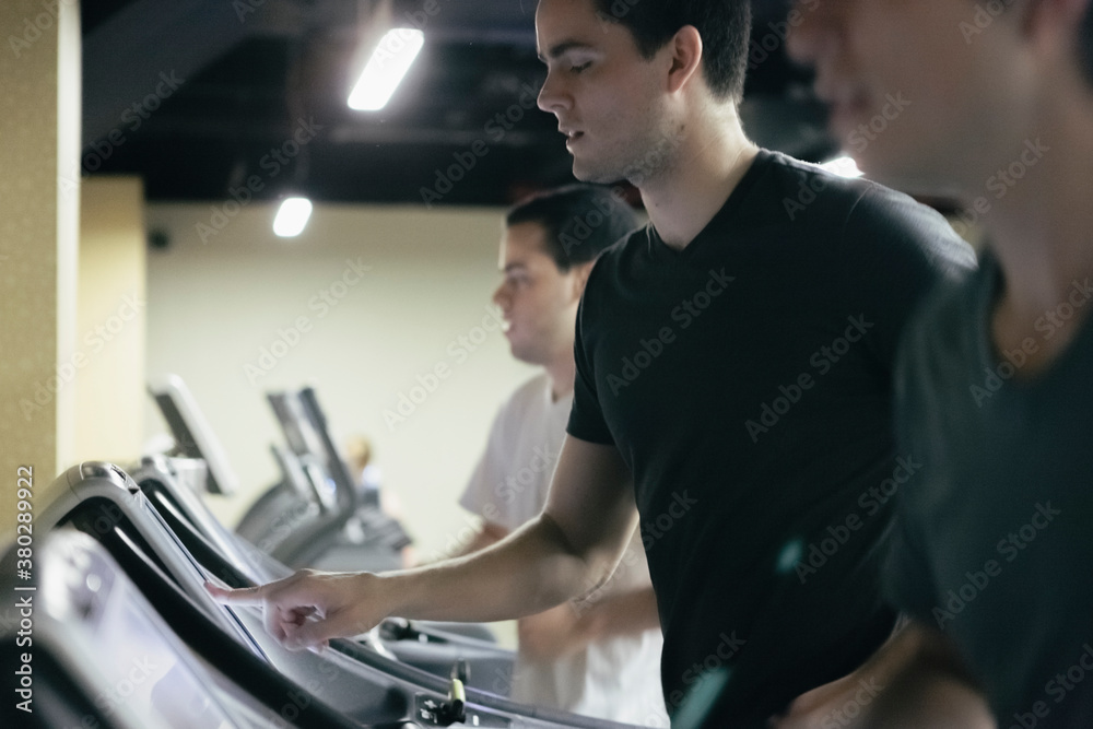 Hispanic Friends and Roommates Running on Threadmill in Gym for Health and Fitness Lifestyle Hispanic Friends and Roommates Running on Threadmill in Gym for Health and Fitness Lifestyle