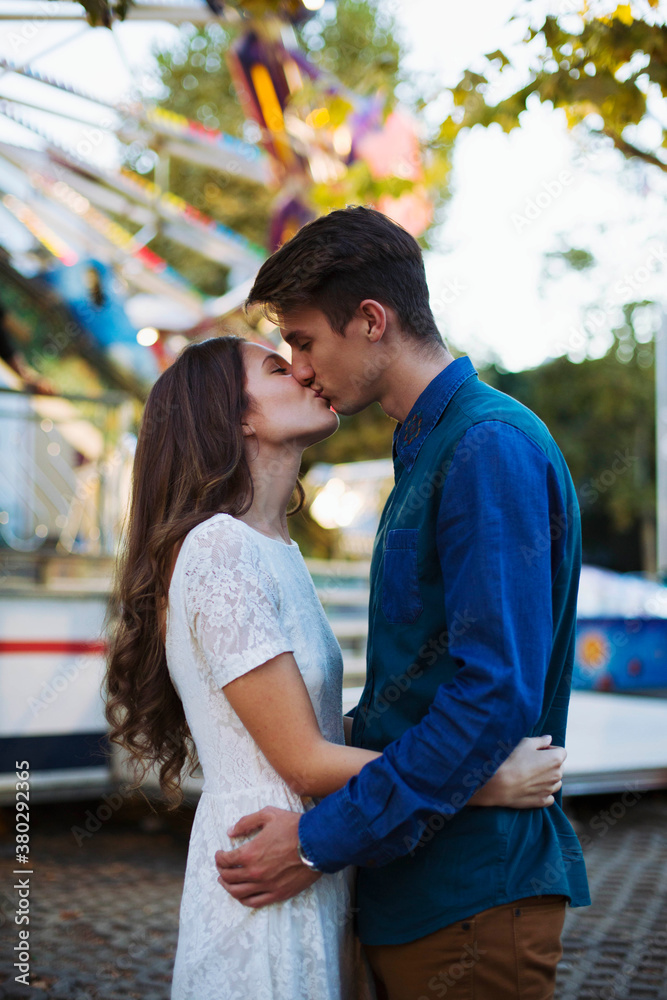 Young couple kissing at the carnival Young couple kissing at the carnival