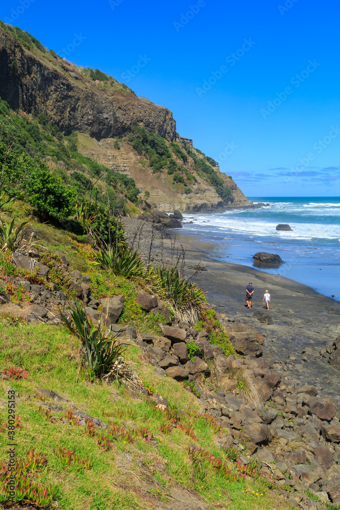 The black sand beach at Maukatia Bay on the west coast of the Auckland Region, New Zealand The black sand beach at Maukatia Bay on the west coast of the Auckland Region, New Zealand