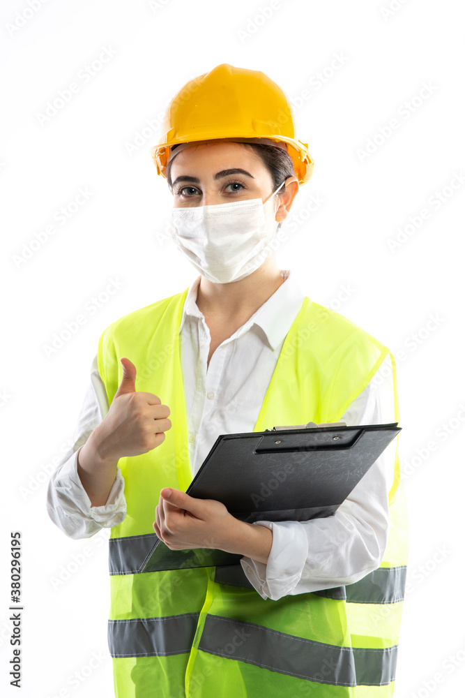 Female engineer wearing protective face mask , protective workwear Female engineer wearing protective face mask , protective workwear