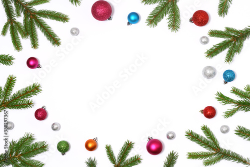Christmas frame of fir branches and colored baubles