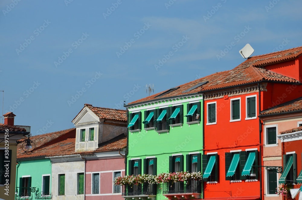 Fototapeta premium Burano island near Venice in Italy, colorful houses, cityscape, blue sky background, copy space 