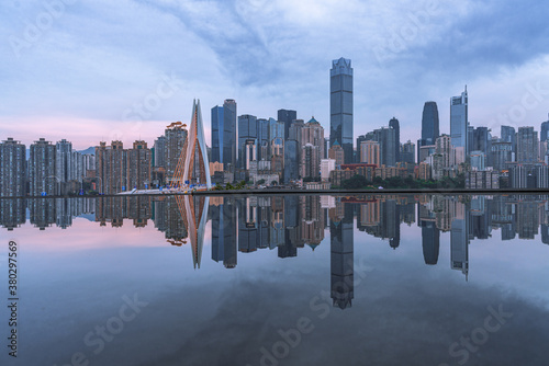 The skyline of downtown Chongqing on a cloudy day  with reflection in front.