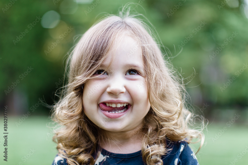 Happy toddler looking playful with her tongue out Happy toddler looking playful with her tongue out