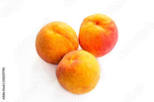 Ripe peaches on a white background and a tree background