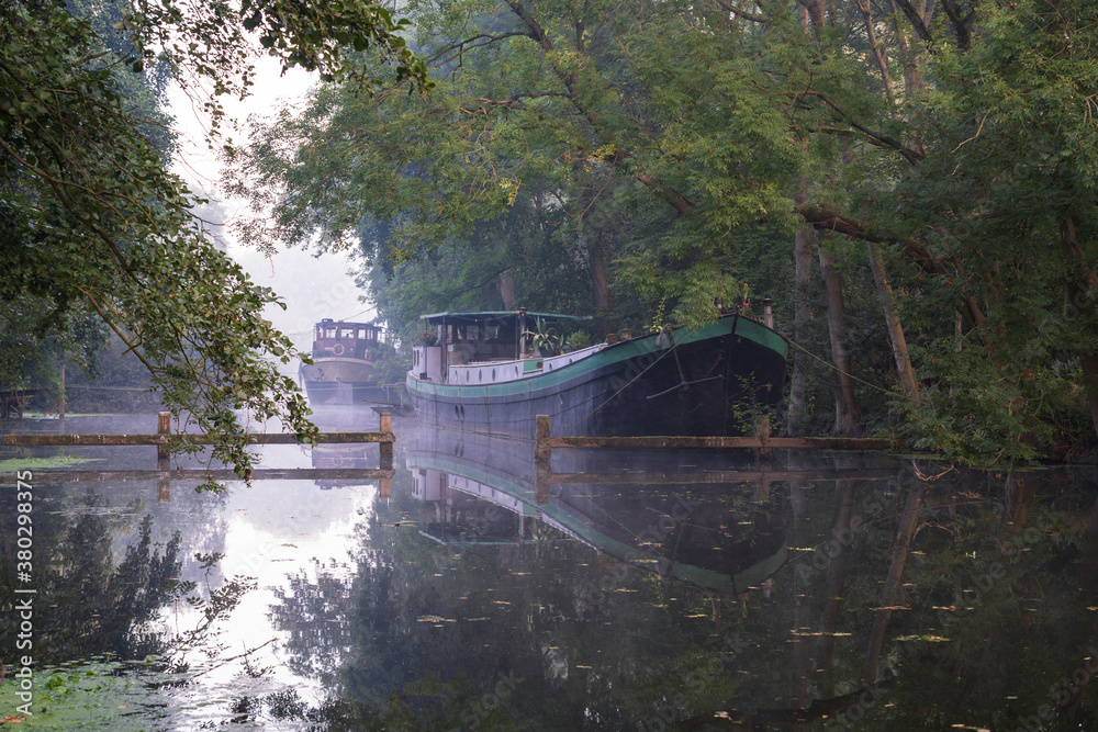 Tranquil, foggy morning at a canal in the Netherlands.