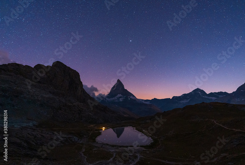 A tent at the Riffelsee, with the Matterhorn in the background, on a clear night.