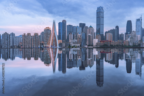 The skyline of downtown Chongqing on a cloudy day  with reflection in front.