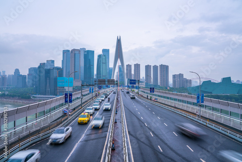 The traffic on qiansimen bridge  with the financial district in Chongqing  China  on a cloudy day.