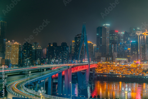 Night view of the Qiansimen bridge and the skyline in Chongqing, China.