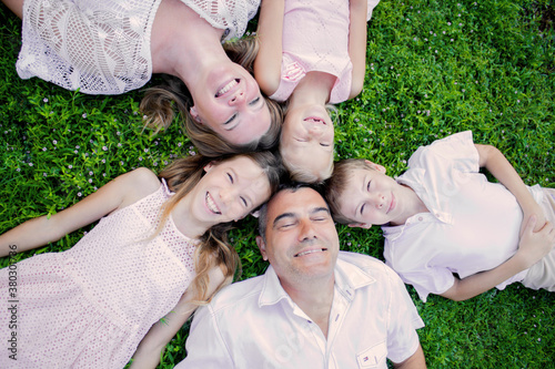 Beautiful family in the summer on a picnic in a green park.
