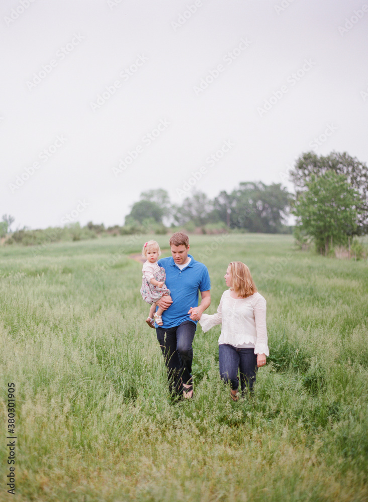 Family walking through a large open landscape Family walking through a large open landscape