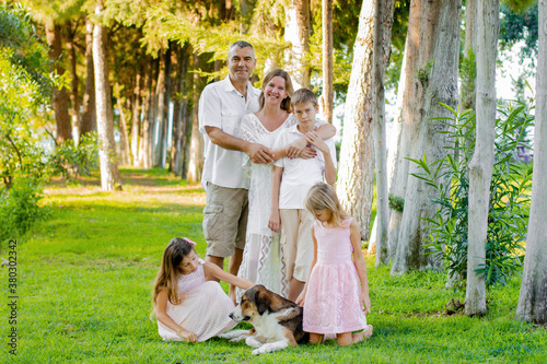 Beautiful family in the summer on a picnic in a green park.