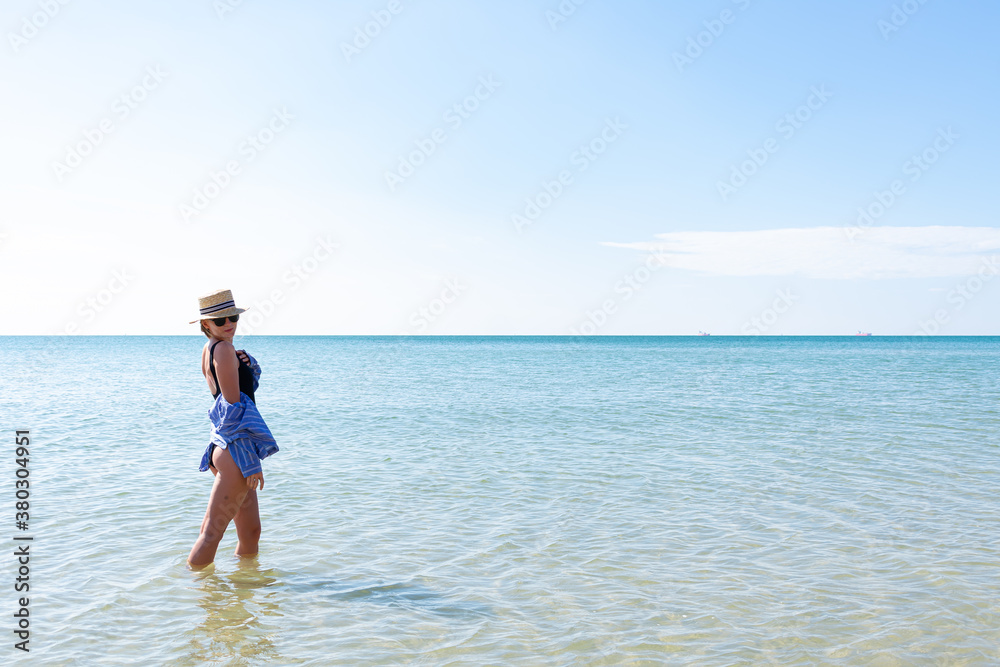 Woman in black swimsuit on the beach