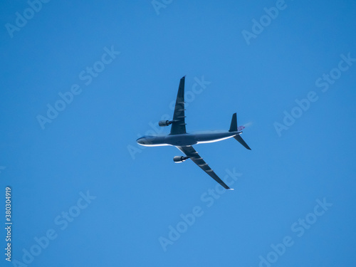 Aeroplane flying high above Sydney Harbour Australia