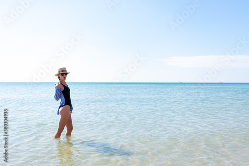 Woman in black swimsuit on the beach