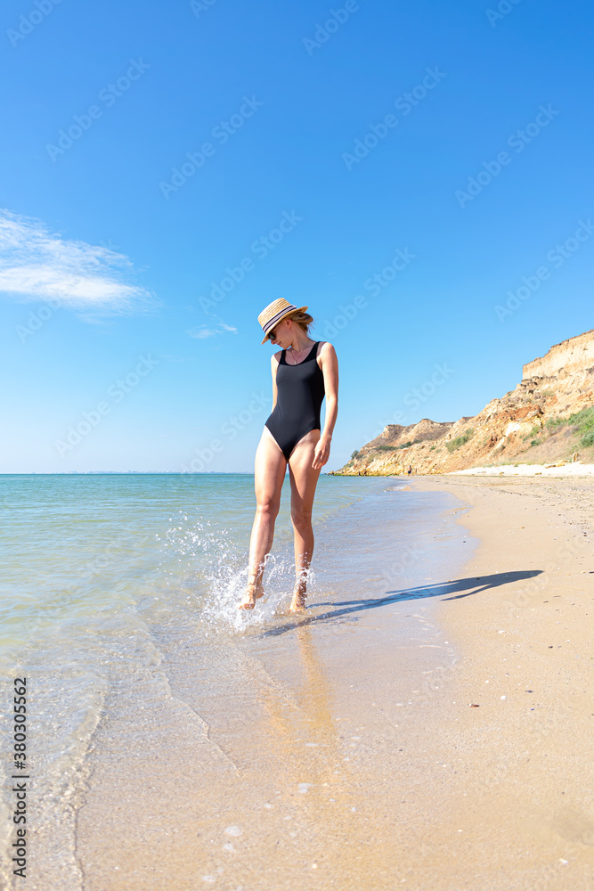Woman in black swimsuit on the beach Woman in black swimsuit on the beach