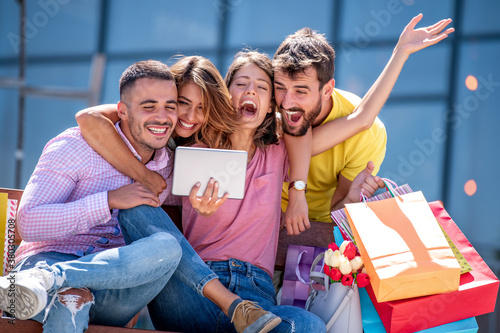 Group of friends take selfie after shopping.