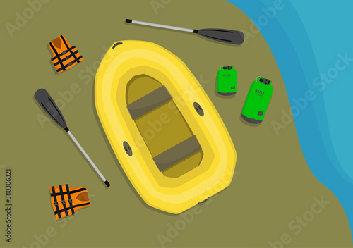 Inflatable boat and other necessary equipment for rafting laying on sand seashore.