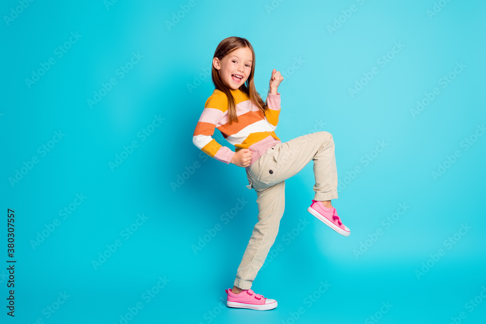 Full length body size profile side view of her she nice attractive pretty lucky glad cheerful cheery girl celebrating great success isolated over bright vivid shine vibrant blue color background Full length body size profile side view of her she nice attractive pretty lucky glad cheerful cheery girl celebrating great success isolated over bright vivid shine vibrant blue color background