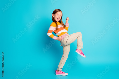 Fototapeta Naklejka Na Ścianę i Meble -  Full length body size profile side view of her she nice attractive pretty lucky glad cheerful cheery girl celebrating great success isolated over bright vivid shine vibrant blue color background