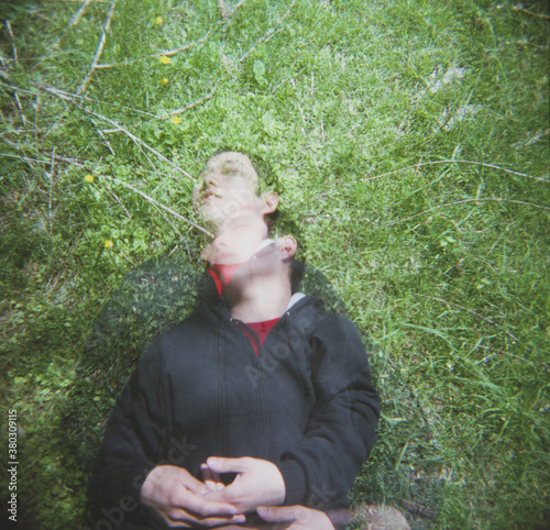 Lying in the grass (multiple exposure) photo